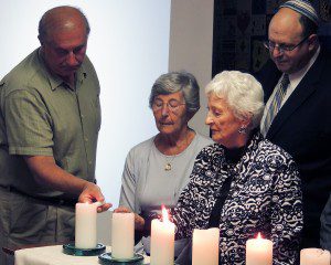 Holocaust Survivors light candles during the 2014 Yom HaShoah Commemoration.